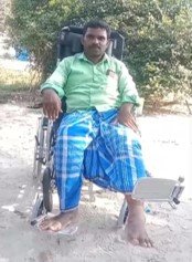 A beneficiary with spinal cord injury seated in his new multipurpose wheelchair